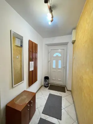a hallway with a door and a room with a table at Cozy Little House Kotor in Kotor