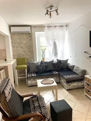 a living room with a couch and a table at Cozy Little House Kotor in Kotor