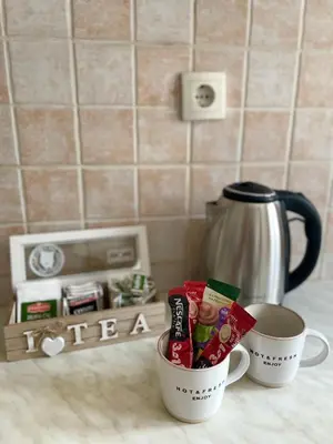 two cups of coffee on a counter with a coffee maker at Cozy Little House Kotor in Kotor