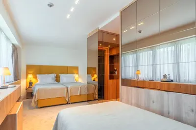 a bedroom with two beds and a large mirror at HOTEL AGAPE in Bar