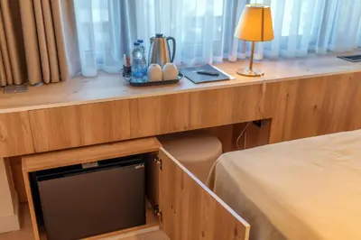 a wooden counter with a desk with a lamp on it at HOTEL AGAPE in Bar