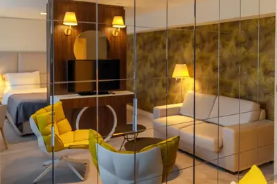 a hotel room with a bed and a living room at HOTEL AGAPE in Bar