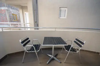 a table and two chairs in a room at Apartments Anita in Budva