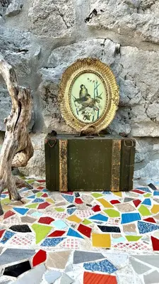 a clock sitting on top of a box on a mosaic floor at Rustic house Pojata in Njeguši