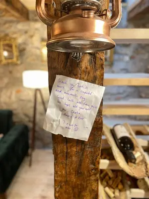 a bottle with a note on it attached to a pole at Rustic house Pojata in Njeguši