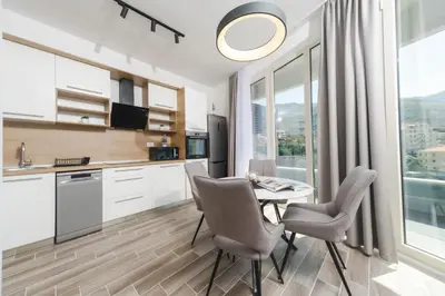 a kitchen and dining room with a table and chairs at Skyline Vista in Becici