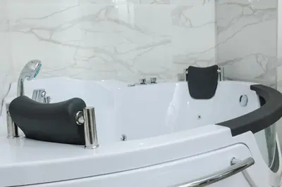 a bathroom with a black and white tub and a sink at Skyline Vista in Becici