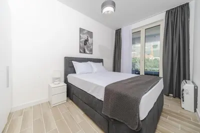 a bedroom with a large bed and a window at Skyline Vista in Becici