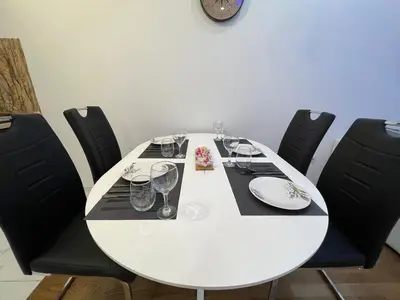a white table with wine glasses on top of it at White Cloud by Rent a Car MI in Podgorica
