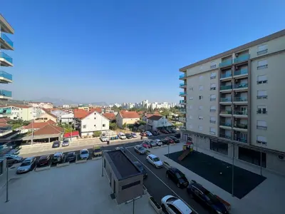 arial view of a parking lot in a city at White Cloud by Rent a Car MI in Podgorica