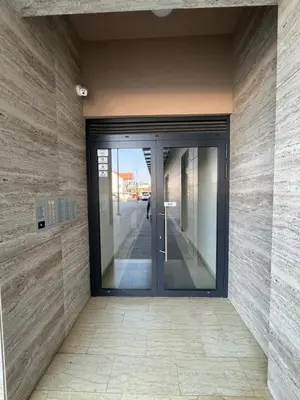 an entrance to a building with a glass door at White Cloud by Rent a Car MI in Podgorica