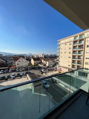 a view of a city from the balcony of a building at White Cloud by Rent a Car MI in Podgorica