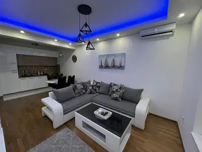 a living room with a couch and a blue ceiling at White Cloud by Rent a Car MI in Podgorica