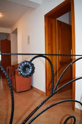 a black metal bed frame in a room at Apartments Kepi Gjerana in Ulcinj