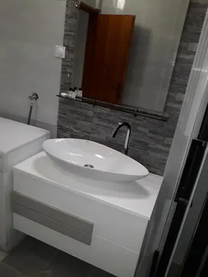 a bathroom with a white sink and a mirror at Belvedere Apartments in Budva