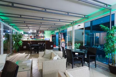 a restaurant with tables and chairs and a bar at Spa Resort Luxury Apartments in Budva