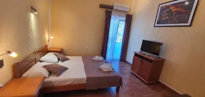 a hotel room with a bed and a television at Martinović Rooms in Budva
