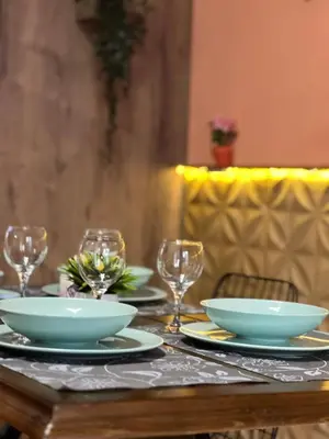 a table with plates and bowls and wine glasses at Sirena Marta in Sutomore