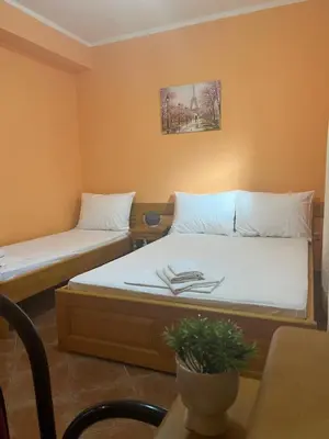 a room with two beds and a table at Sirena Marta in Sutomore