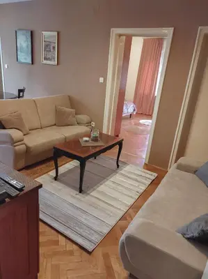 a living room with a couch and a coffee table at Center 1 Podgorica in Podgorica