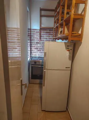 a kitchen with a white refrigerator and a stove at Center 1 Podgorica in Podgorica