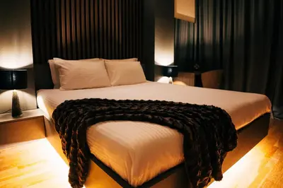 a bedroom with a large bed with a blanket on it at Luxury Apartment Budva in Budva