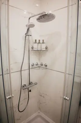 a shower with a hose in a bathroom at Luxury Apartment Budva in Budva