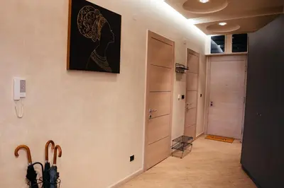 a hallway with wooden closets and a painting on the wall at Luxury Apartment Budva in Budva