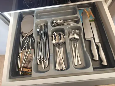 a drawer filled with silver utensils in a drawer at Luxury Apartment Budva in Budva