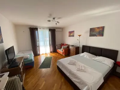 a bedroom with a bed and a living room at BLUE EYES SAILORS in Kotor