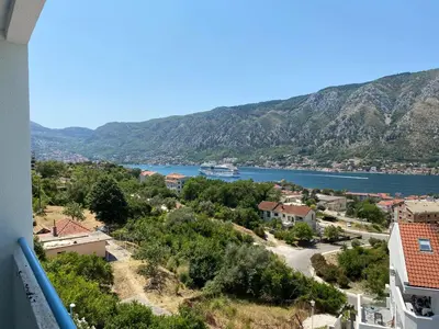a view of a town and a river with mountains at BLUE EYES SAILORS in Kotor