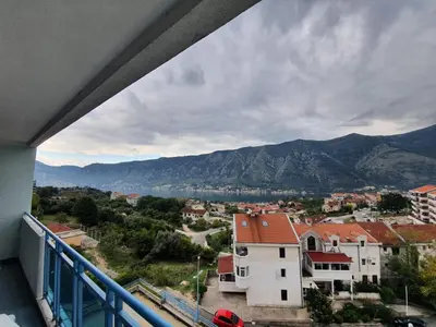 a balcony with a view of a city and mountains at BLUE EYES SAILORS in Kotor