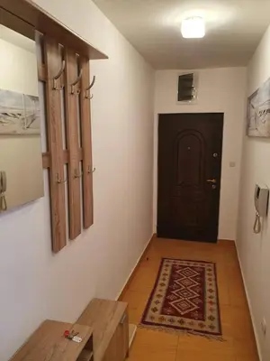 a hallway with a black door and a rug at BLUE EYES SAILORS in Kotor