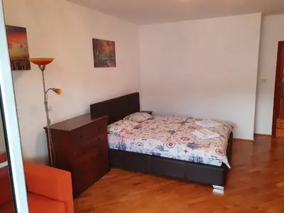 a bedroom with a bed and a dresser in it at BLUE EYES SAILORS in Kotor