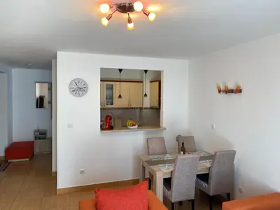 a dining room and kitchen with a table and chairs at BLUE EYES SAILORS in Kotor