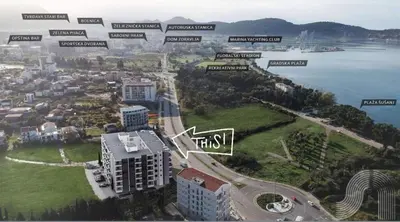 an aerial view of a city with buildings and the water at Lux Stanovi Vucetic in Bar