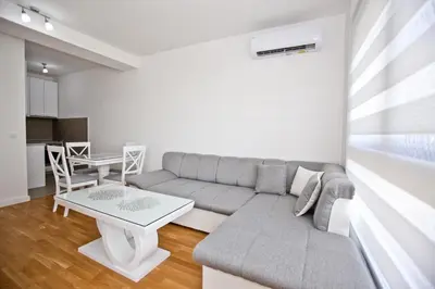 a living room with a couch and a table at Lux Stanovi Vucetic in Bar