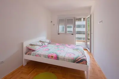 a small bedroom with a bed in a room at Apartment Ana in Budva