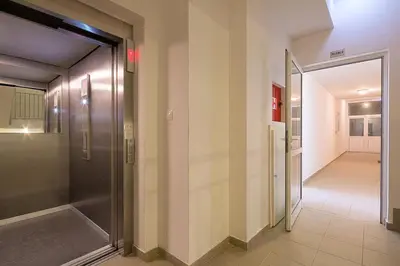 a hallway with a glass door and a hallway leading to a hallway at Apartment Ana in Budva