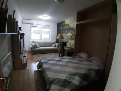 a bedroom with a bed and a couch at Apartment Ana in Budva