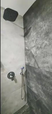 a shower in a bathroom with a shower head at Artemis Apartment in Ulcinj
