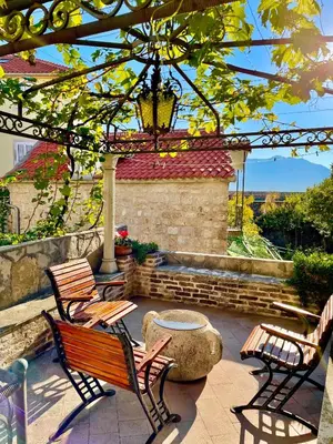 a patio with two benches and a pergola at Heart of old town,Private garden ,Stunning View, Free Wi-Fi in Budva