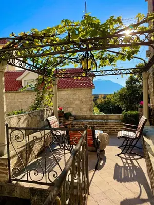 a patio with chairs and a pergola at Heart of old town,Private garden ,Stunning View, Free Wi-Fi in Budva