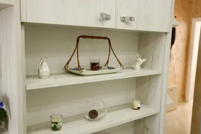 a shelf with vases and candles on it at Apartment Alexandar in Podgorica