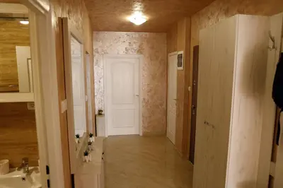 a hallway of a bathroom with a sink and a door at Apartment Alexandar in Podgorica
