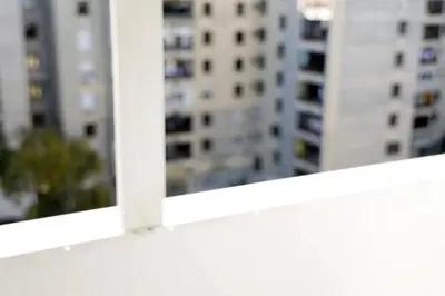 a white window sill with buildings in the background at Apartment Alexandar in Podgorica