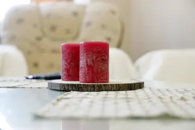 two red candles sitting on a table next to a keyboard at Apartment Alexandar in Podgorica