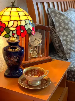 a table with a clock and a cup of tea on it at Apartments Nuhi in Ulcinj