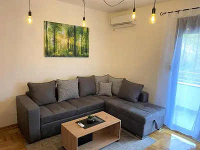 a living room with a couch and a table at MonteRelax Apartments Becici in Rafailovici
