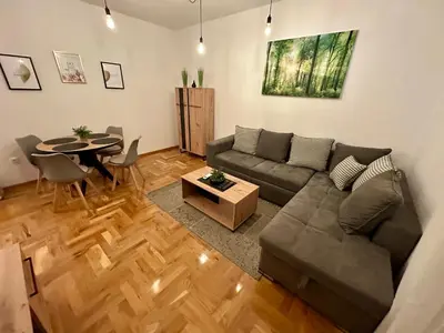 a living room with a couch and a table at MonteRelax Apartments Becici in Rafailovici